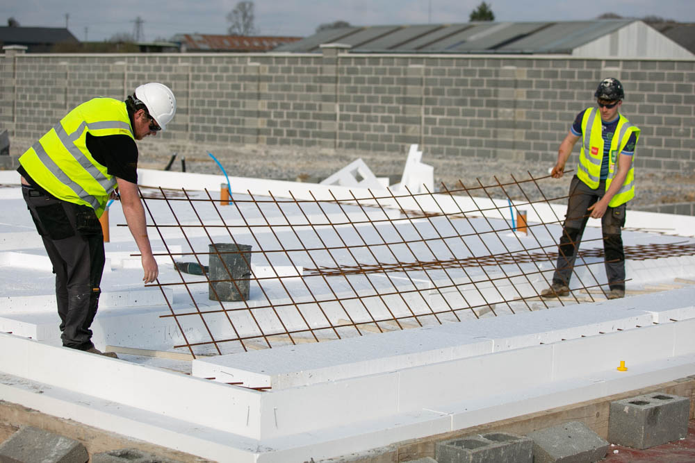 Workers installing steel reinforcement on KORE Insulated Foundation System